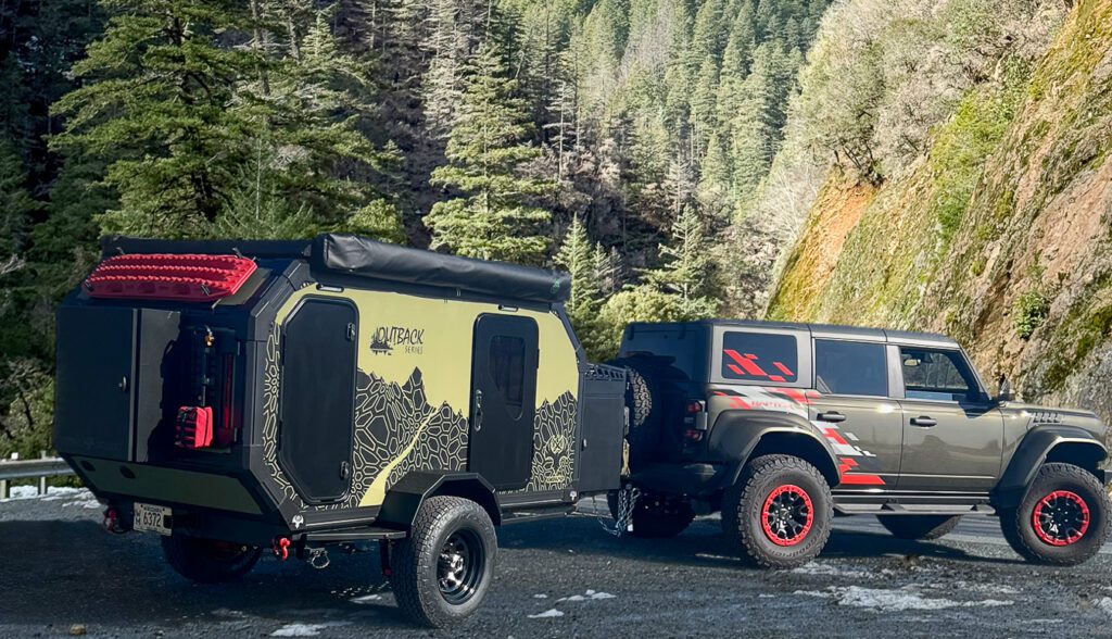 OB120 being pulled by a Ford Bronco Raptor through the forest.