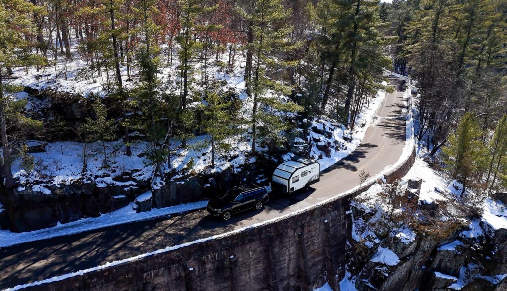 S145 driving along a cliff in the winter time.