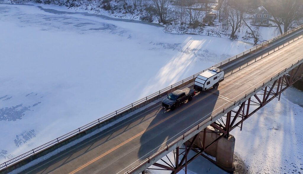 Imperial Outdoors S195 driving above the frozen river on the bridge.
