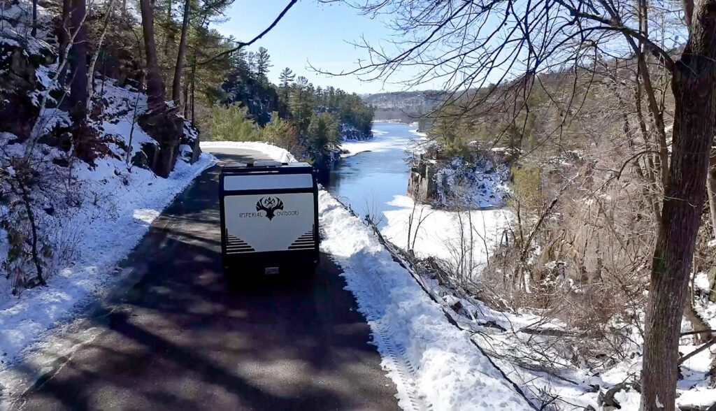 Imperial Outdoor S195 driving along the river bluffs covered in snow.