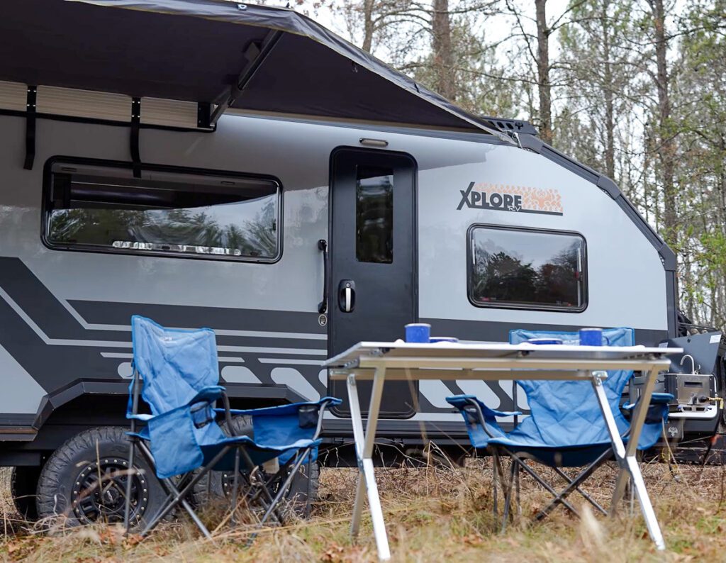 Off grid camping in the forest in the Gray Imperial Outdoors Xplore Series X195 camper.