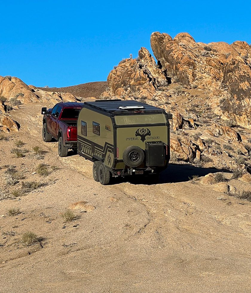 Driving along a rocky tight path terrain in California with the Imperial Outdoors X195.