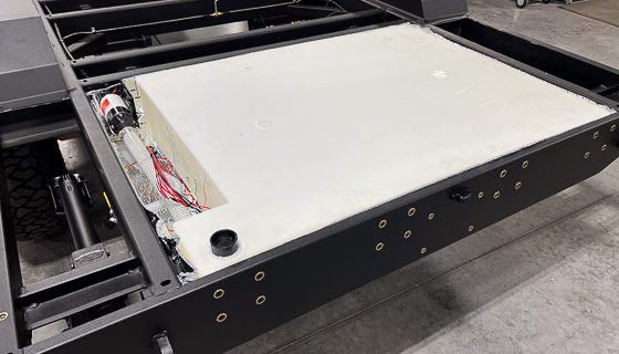 Imperial Outdoors insulated and heated holding tank nested in rugged chassis with aluminum skid plates.
