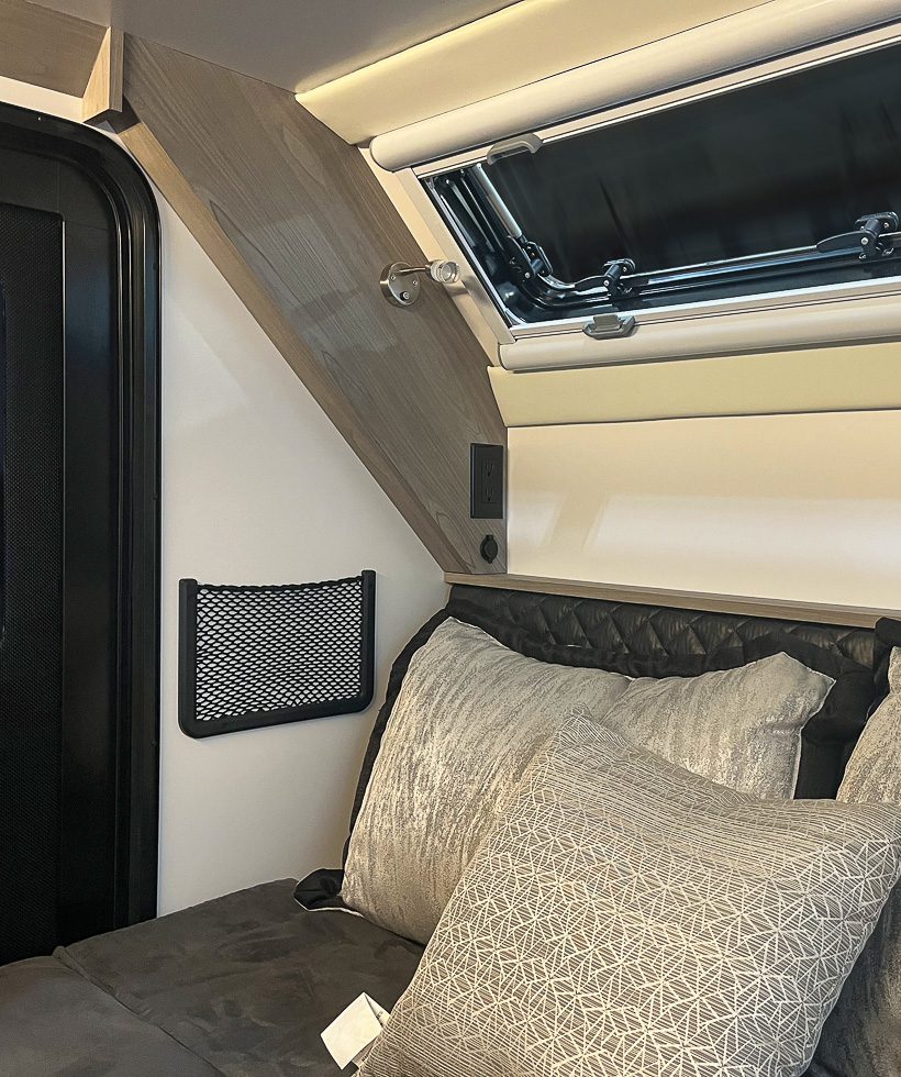 The imperial Outdoors OB120 bed in lay down position with cubby netting along side the bed.