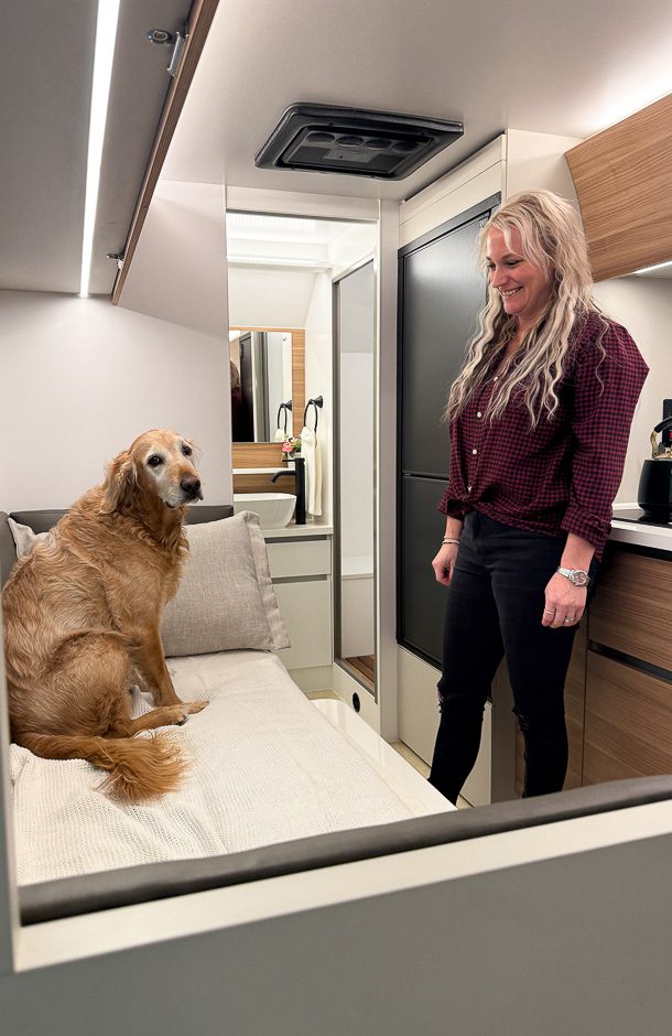Lady and dog setting up dinette for the dog to have place to sleep.