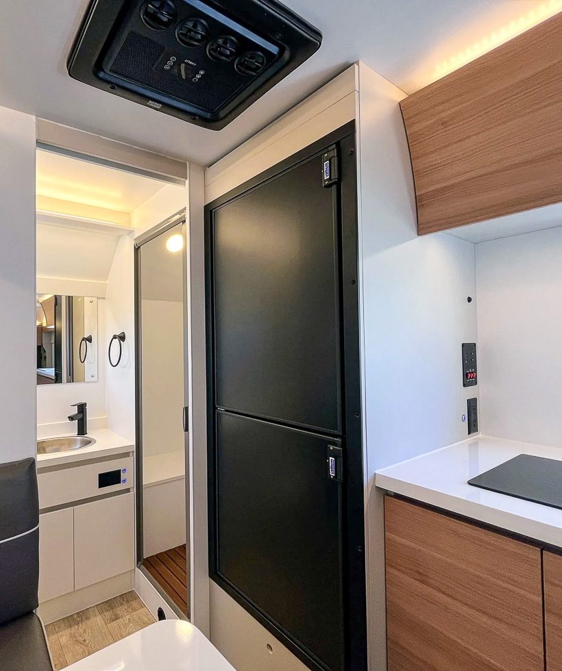 Black 12v fridge and freezer in the kitchen of the S195.