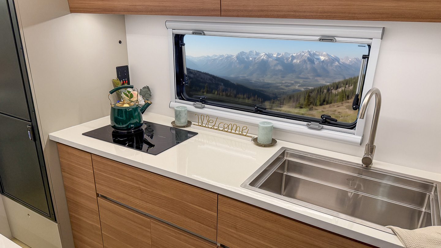 Sport Series S195 kitchen looking out the large kitchen window to a view of the mountains.