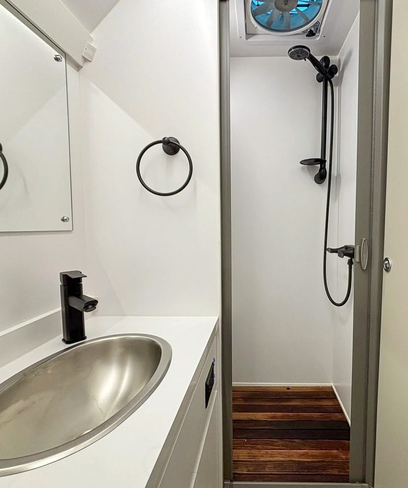 Spacious bathroom with a teak wood floor in the Sport Series from Imperial Outdoors.