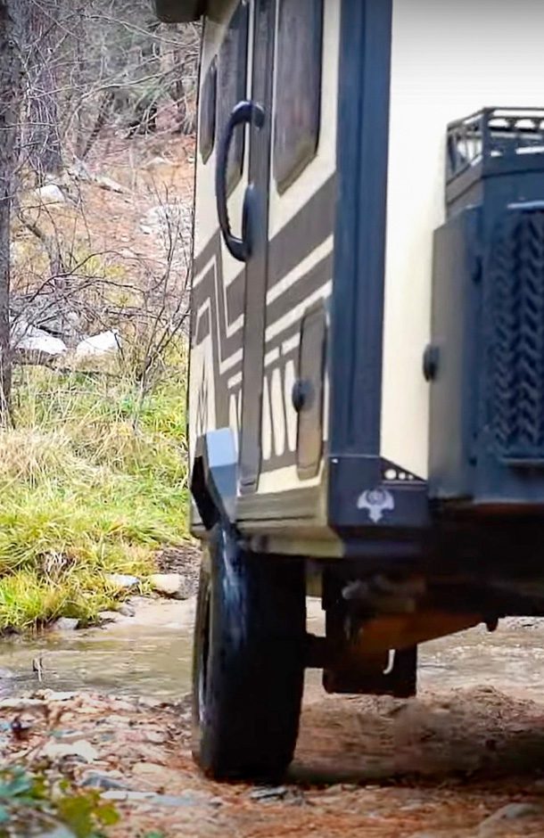 The X145 from Imperial Outdoors traveling along a narrow path in the woods.