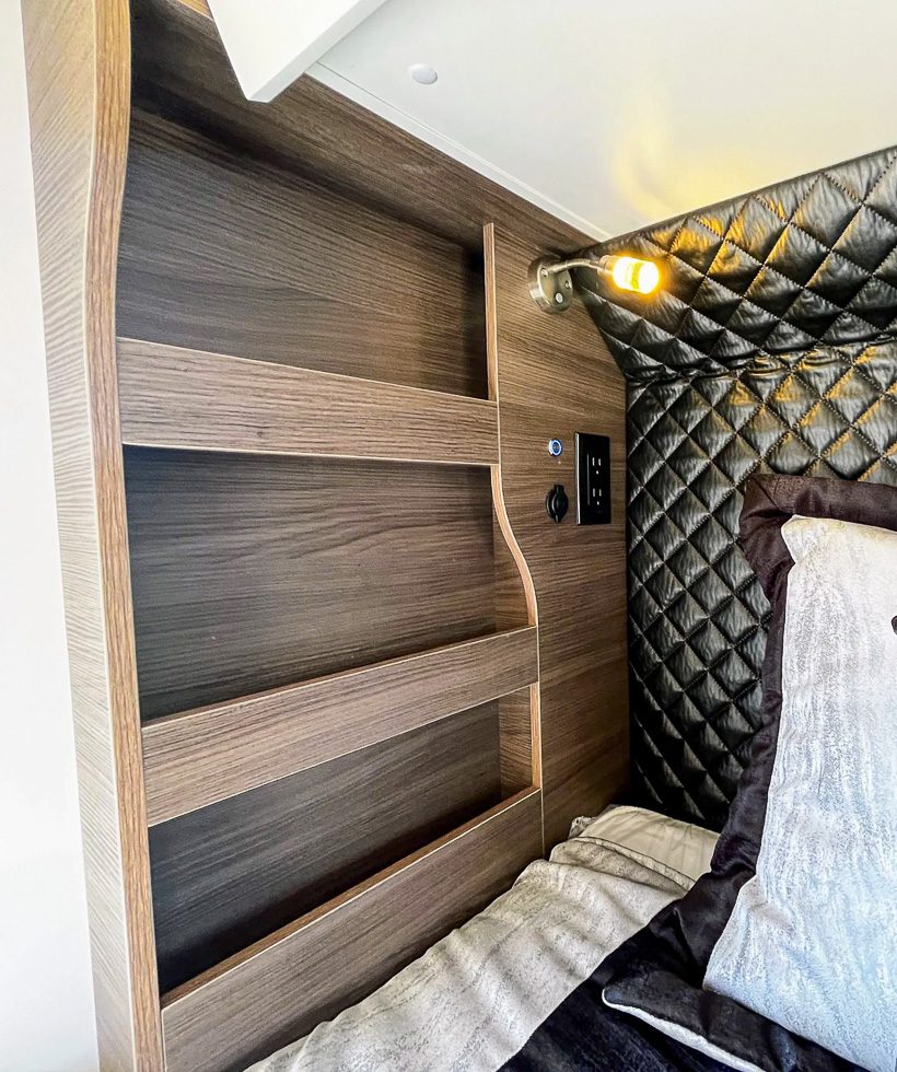 Bedside cubby and lighting on the king size bed in the Imperial Outdoors X195.