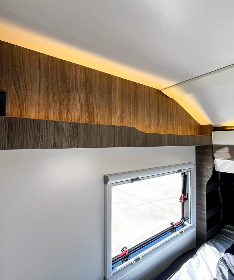 Lighting and shelf above the king size bed in the Imperial Outdoors X195 off grid trailer.