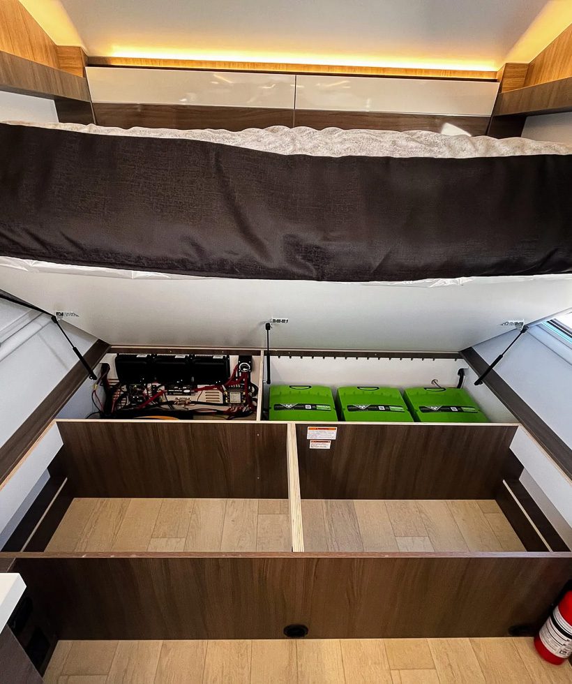 Storage and electronics and batteries under the kit size bed on the Imperial Outdoors X195 trailer.
