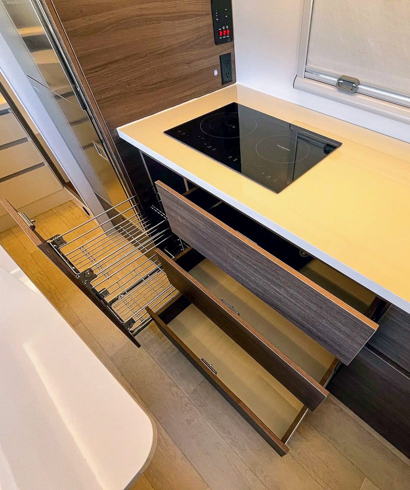 Dual induction cooktop and pulled out kitchen drawers and wire basket to hold any of you cooking needs in the Imperial Outdoors X195.