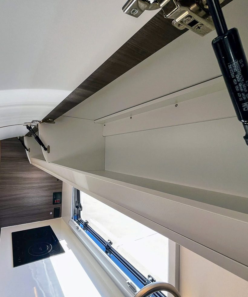 Upper cabinets and storage above the kitchen in the Imperial Outdoors X195.