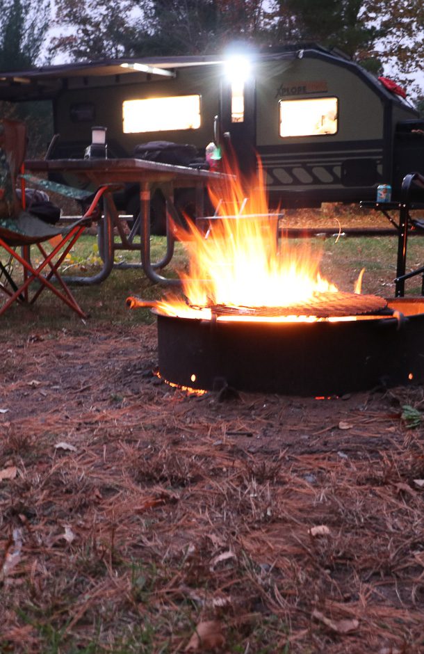Evening campfire in front of Imperial Outdoors Xplore Series X195.