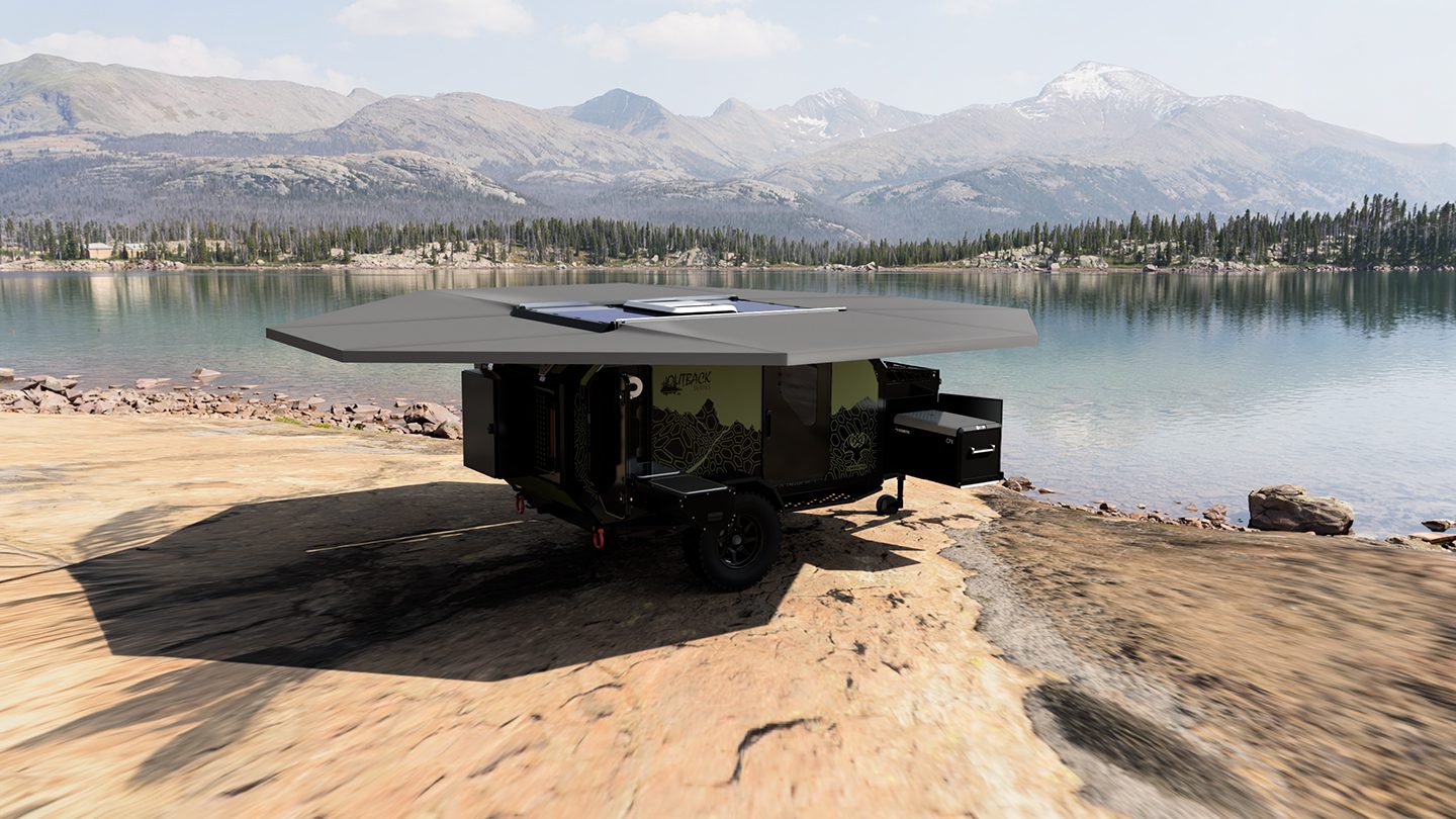 Imperial Outdoor OB120 camped beside a lake with the awning deployed.