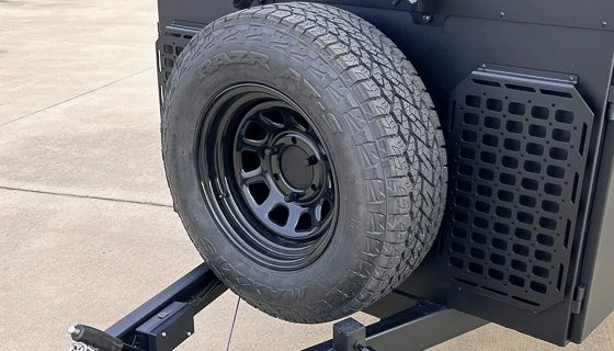 Imperial Outdoors OB120 front box has a spare tire and molle boards installed.