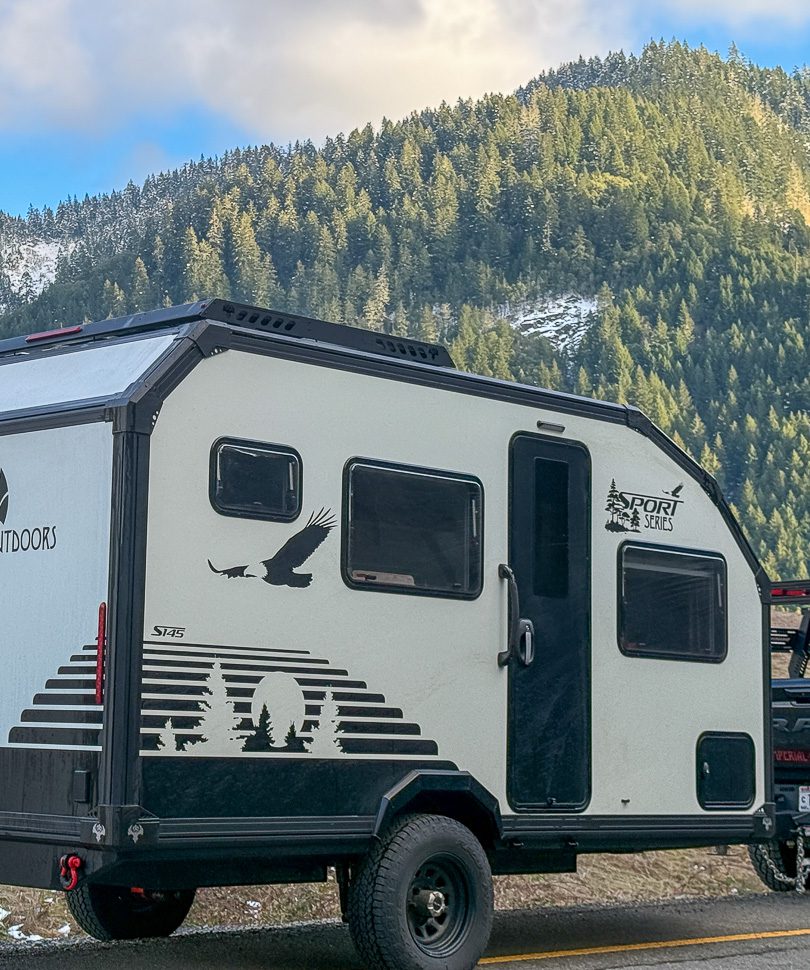 Imperial Outdoors Sport Series S145 traveling along a dirt road in the forest.