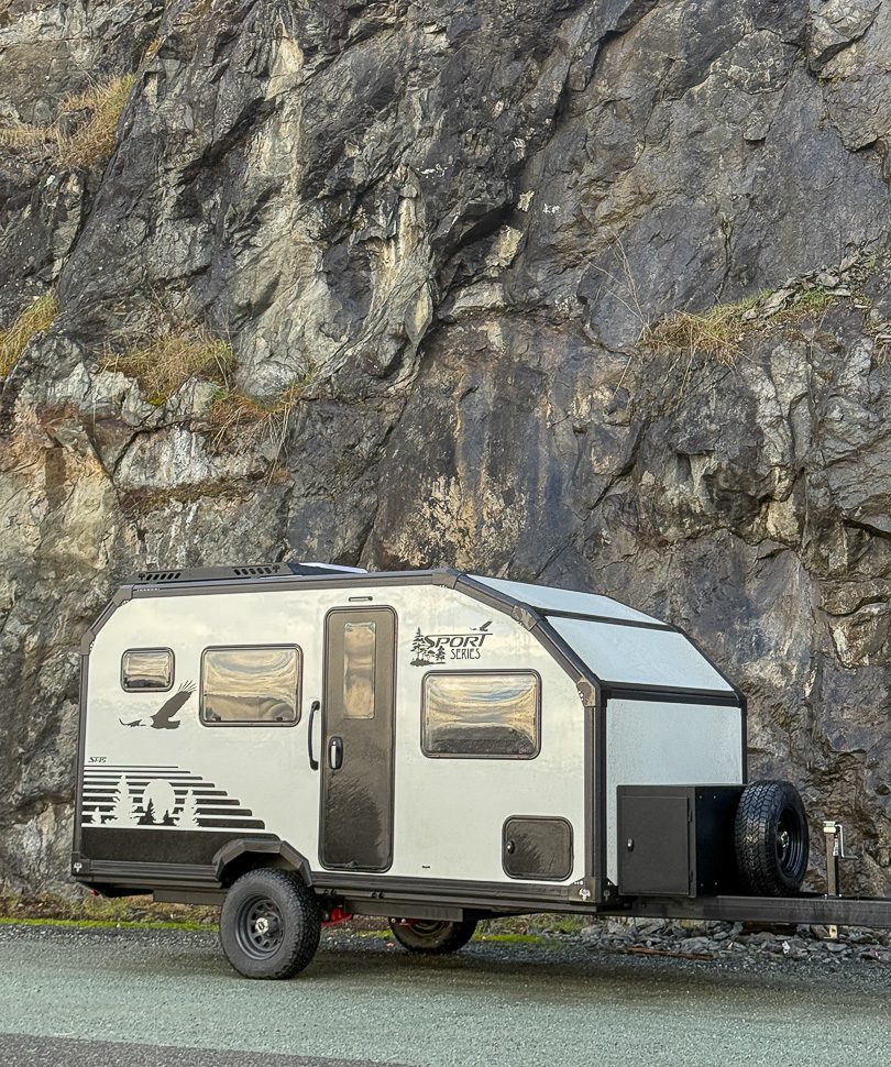 Imperial Outdoors Sport Series S145 camped next to a rocky wall in the mountains.