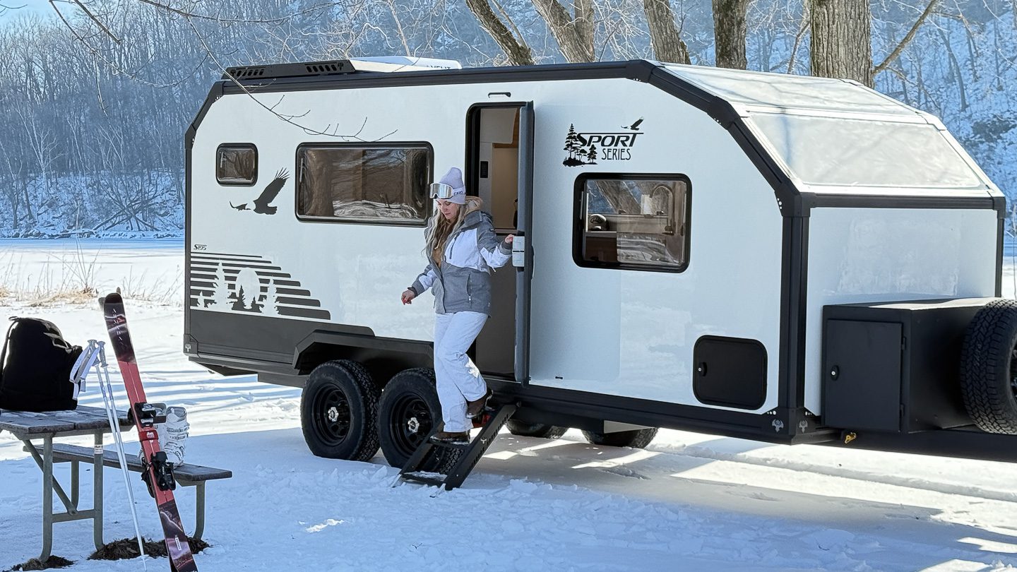 Imperial Outdoors Sport Series S195 at a winter basecamp with the lady getting ready to go skiing in the mountains.