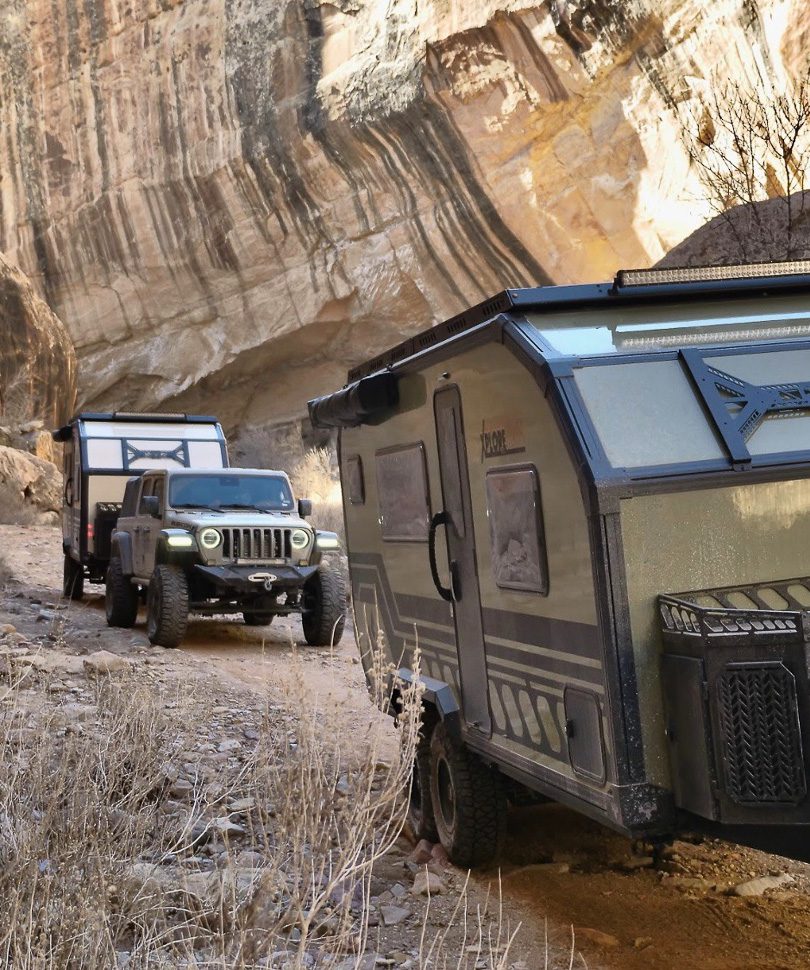 Imperial Outdoors Xplore Series campers in a deep canyon trail in Utah along a rock wall.