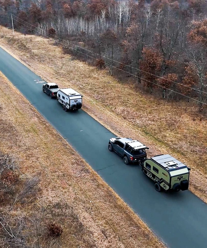 Imperial Outdoors Xplore Series campers driving down country road.