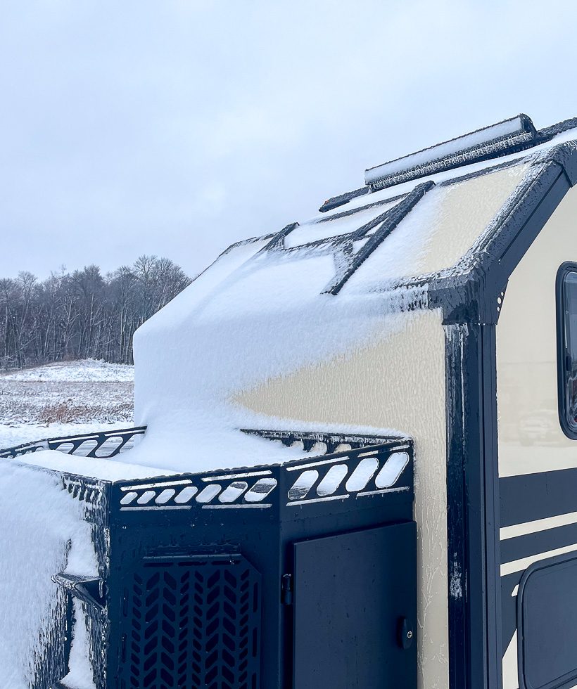 Imperial Outdoors Xplore Series extreme cold weather camping with the camper covered in snow and ice.